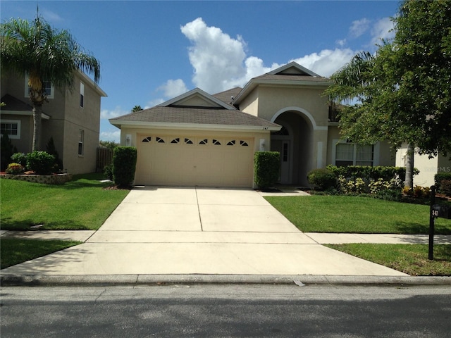 view of front facade with a garage and a front yard