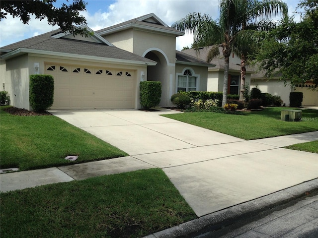 view of front of property with a garage and a front yard