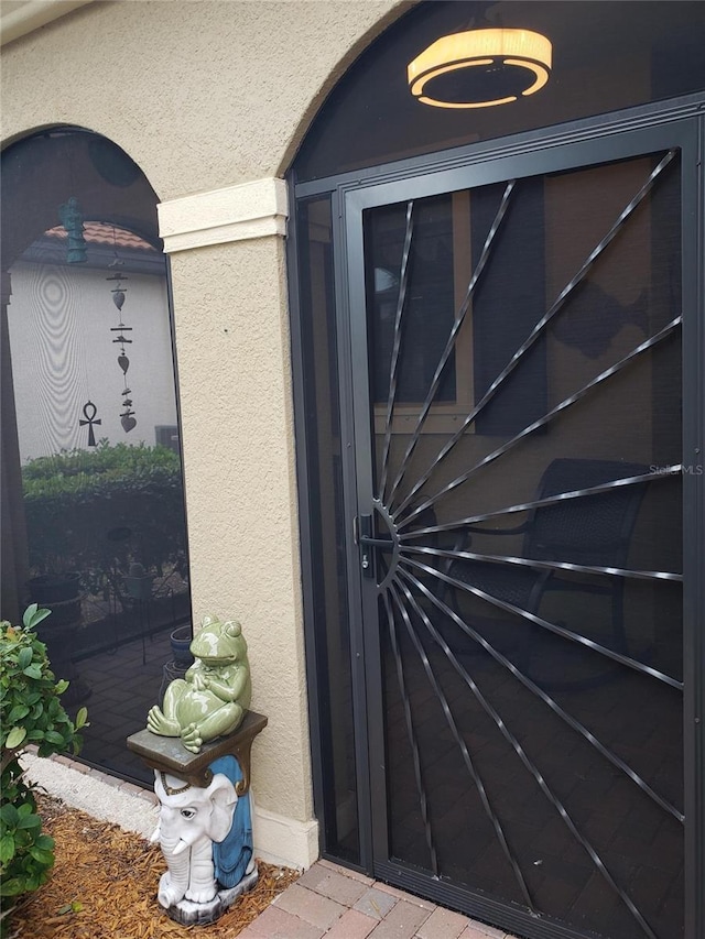 property entrance with stucco siding