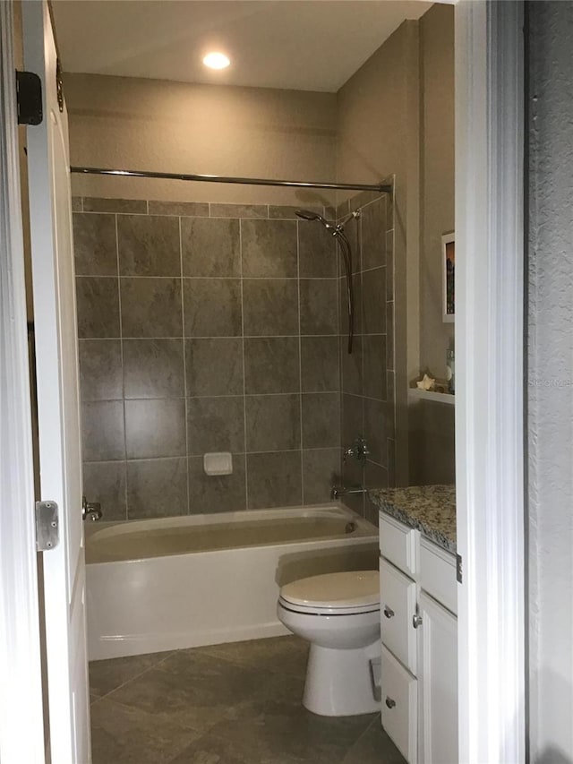 full bath featuring toilet, tile patterned flooring, bathtub / shower combination, and vanity