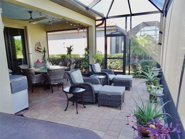 view of patio with a lanai, ceiling fan, and an outdoor living space