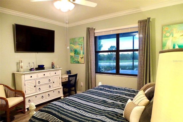 bedroom with a ceiling fan, crown molding, and wood finished floors