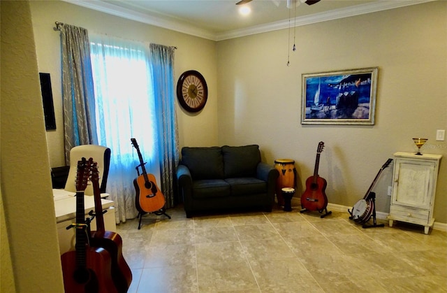 living area with ornamental molding, a ceiling fan, and baseboards