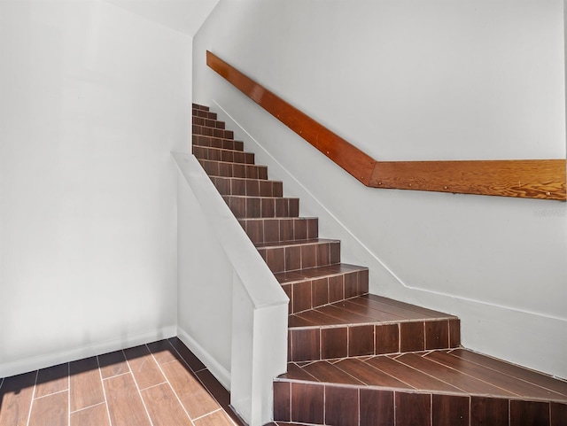 staircase with hardwood / wood-style flooring