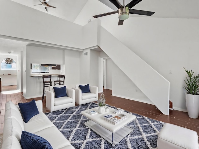 living room featuring dark wood-type flooring and high vaulted ceiling