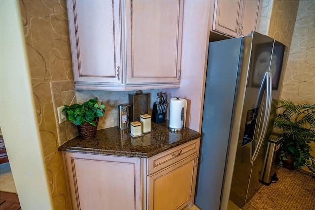 7500 Toscana Blvd Unit 341, Orlando, FL 32819 - kitchen featuring stainless steel refrigerator with ice dispenser, dark stone counters, and tasteful backsplash