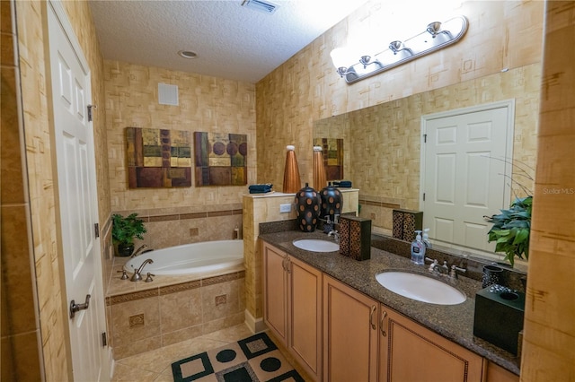 7500 Toscana Blvd Unit 341, Orlando, FL 32819 - full bathroom featuring tile patterned flooring, a garden tub, double vanity, and a textured ceiling