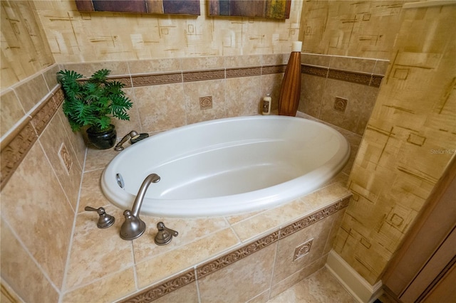 bathroom featuring a bathtub and tile walls