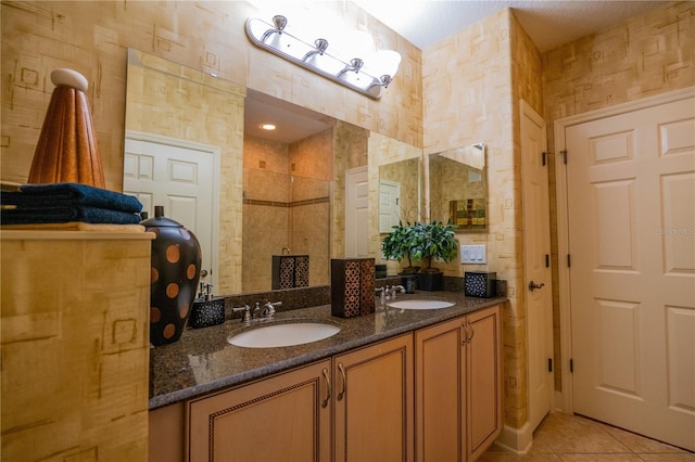 7500 Toscana Blvd Unit 341, Orlando, FL 32819 - bathroom featuring tile patterned flooring, double vanity, and tiled shower