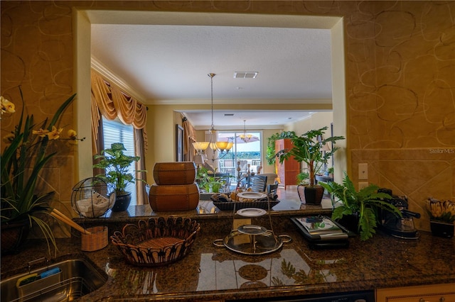 dining space featuring ornamental molding and a notable chandelier