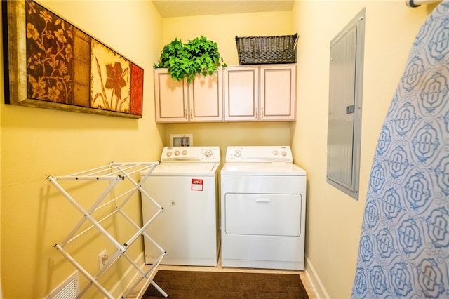 washroom featuring cabinets, independent washer and dryer, and electric panel