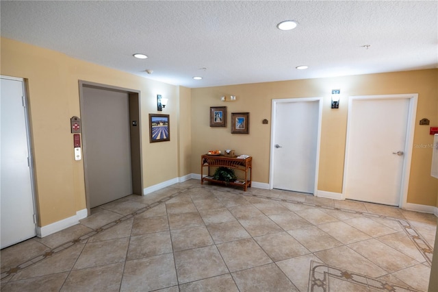 7500 Toscana Blvd Unit 341, Orlando, FL 32819 - spare room with elevator, recessed lighting, light tile patterned floors, a textured ceiling, and baseboards