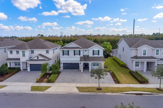 view of front of property with a garage and a front lawn