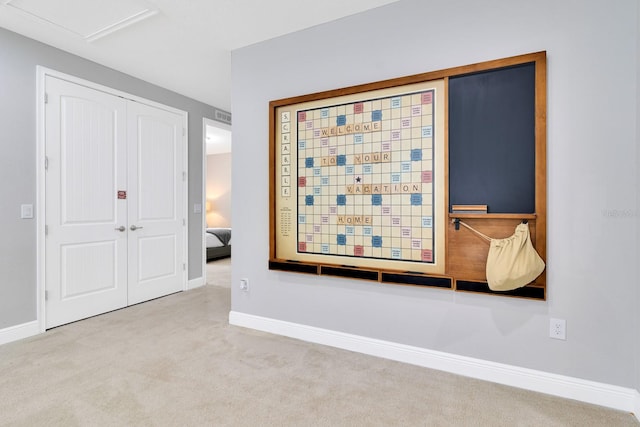 unfurnished bedroom featuring light colored carpet and a closet