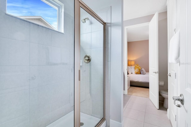 bathroom featuring tile patterned floors, an enclosed shower, and toilet