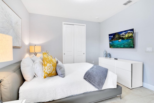 bedroom featuring light carpet and a closet