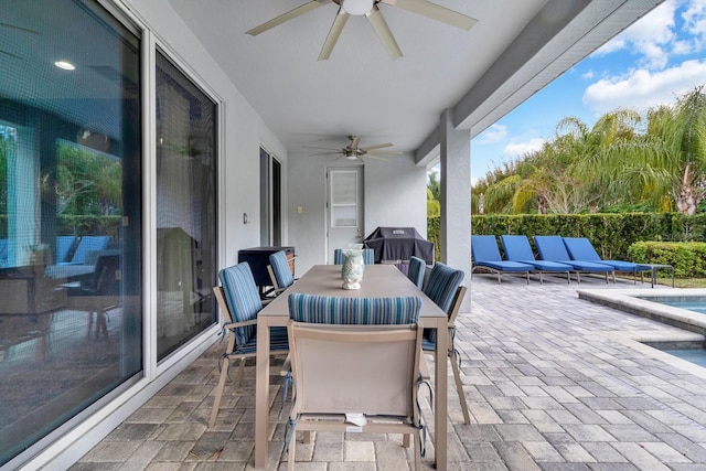 view of patio featuring area for grilling, ceiling fan, and an outdoor living space