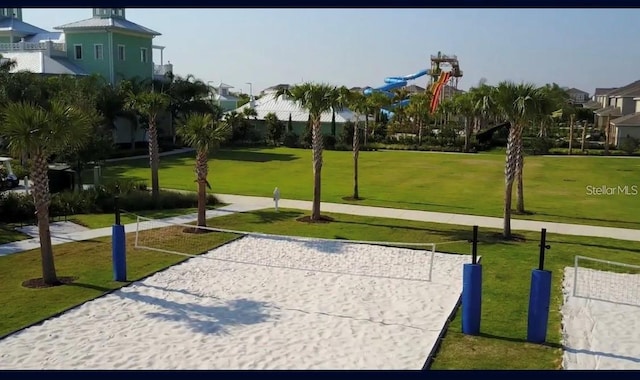 view of property's community featuring volleyball court and a lawn