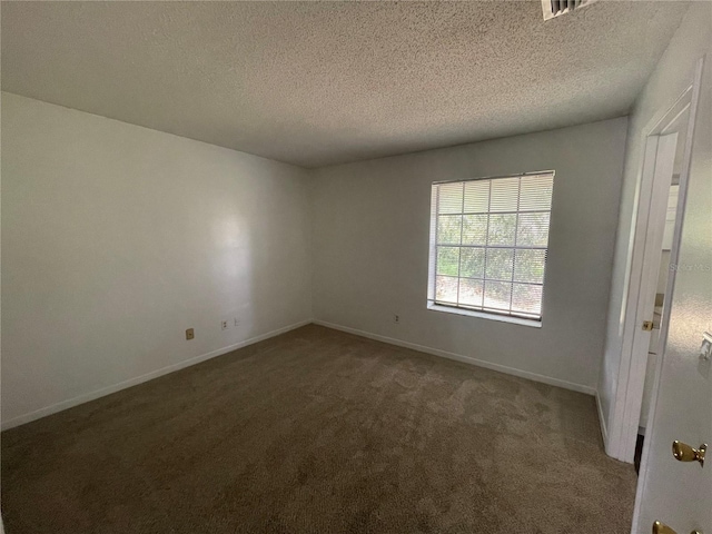 empty room featuring carpet flooring and a textured ceiling