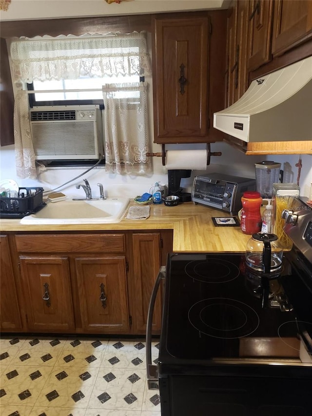 kitchen with black electric range and sink