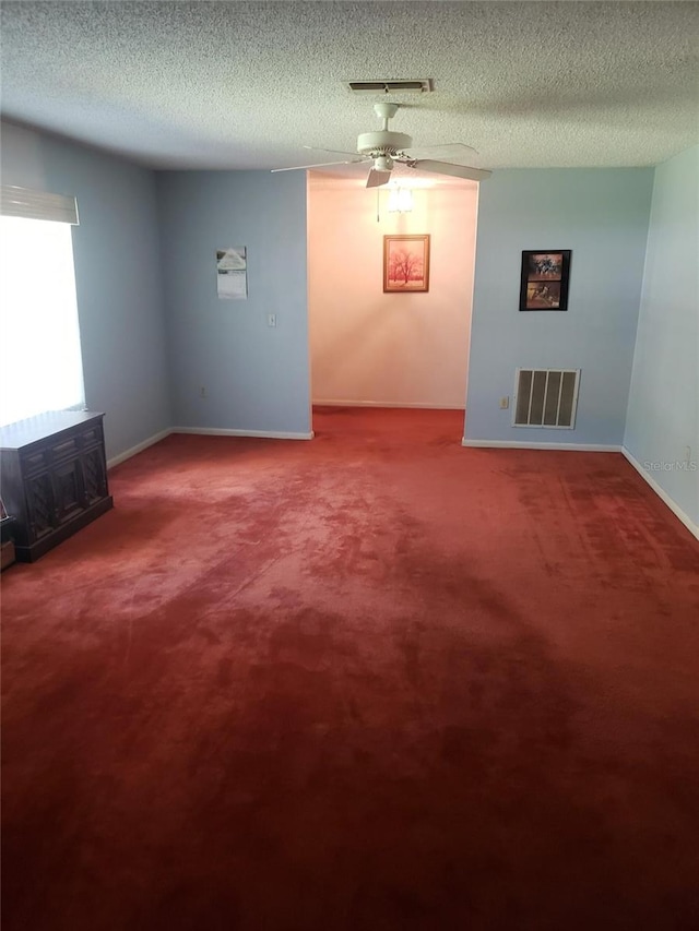 carpeted spare room featuring a textured ceiling