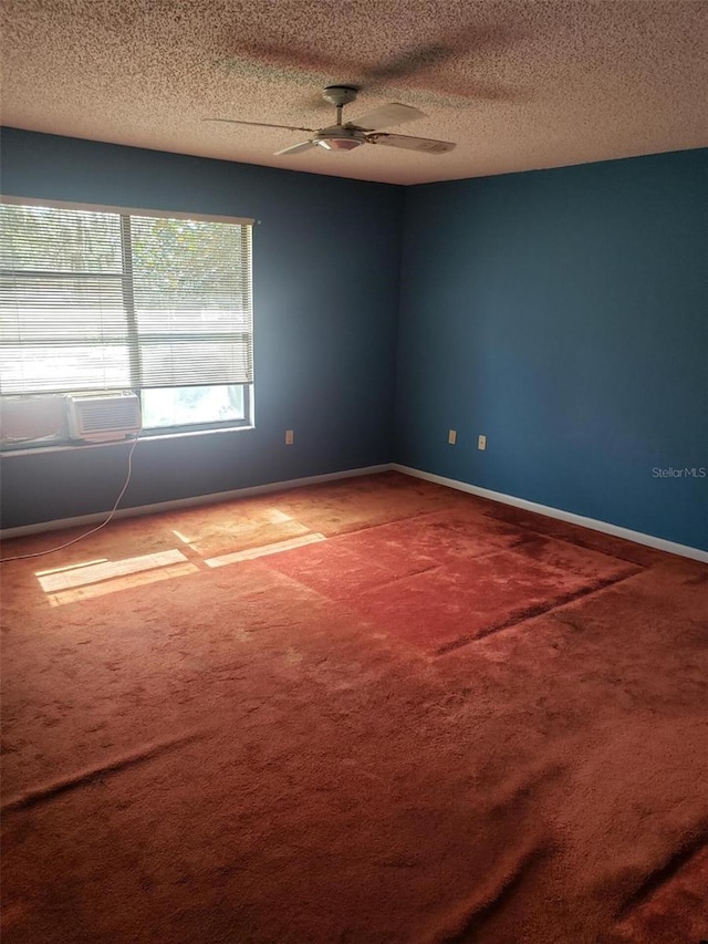 carpeted empty room with ceiling fan and a textured ceiling