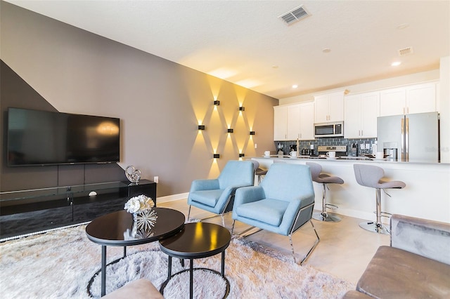 8943 Cabot Cliffs Dr, Davenport, FL 33896 - living room with recessed lighting and finished concrete floors