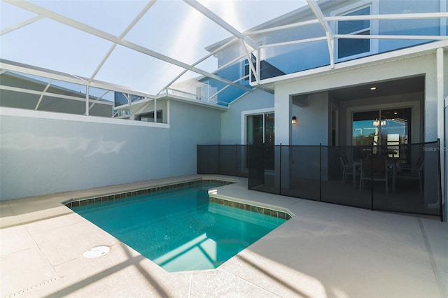 view of swimming pool featuring a patio and a lanai