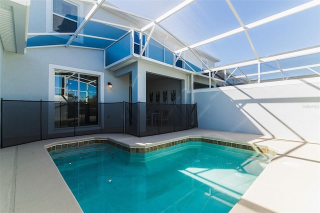 view of swimming pool with a patio and glass enclosure