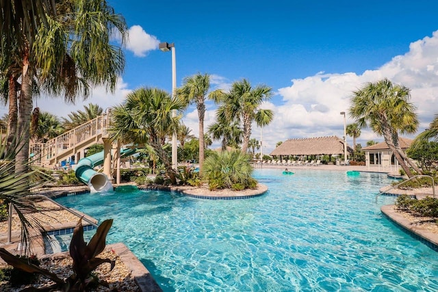 view of swimming pool with a water slide