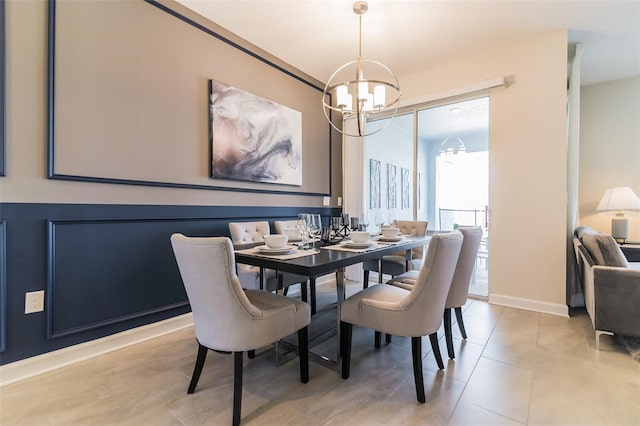 dining room featuring a chandelier, baseboards, and light tile patterned floors