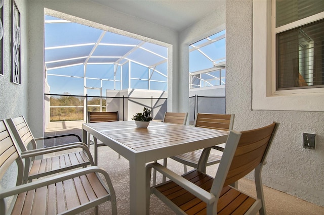 sunroom featuring vaulted ceiling and outdoor dining space