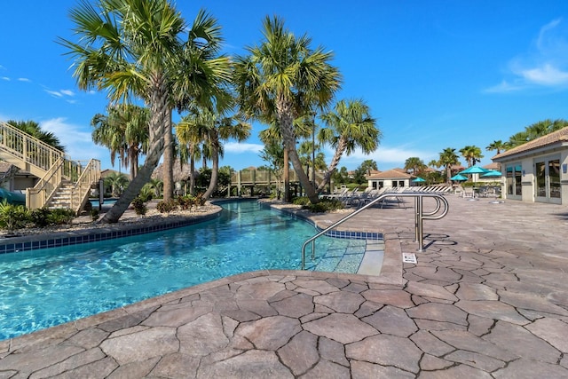 community pool featuring a patio and stairway