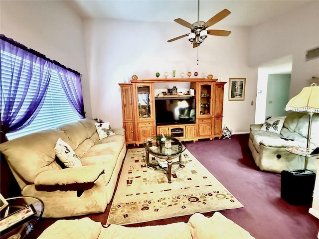 living room with dark colored carpet, high vaulted ceiling, and ceiling fan