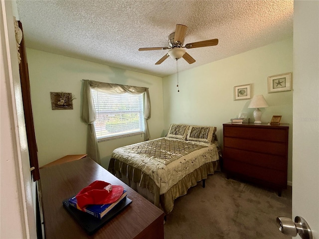 carpeted bedroom featuring a textured ceiling and ceiling fan