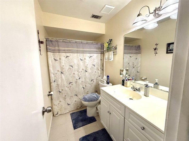 bathroom featuring tile patterned flooring, vanity, and toilet