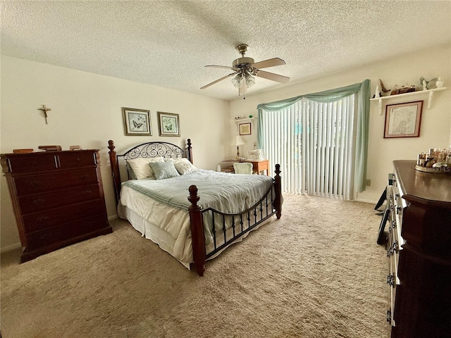 carpeted bedroom with a textured ceiling and ceiling fan