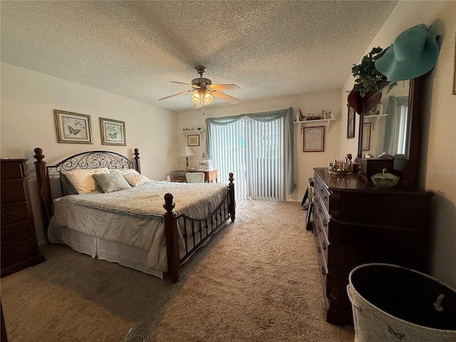 bedroom with a textured ceiling, carpet floors, and ceiling fan