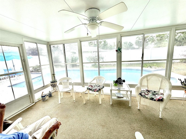 unfurnished sunroom with ceiling fan and a healthy amount of sunlight