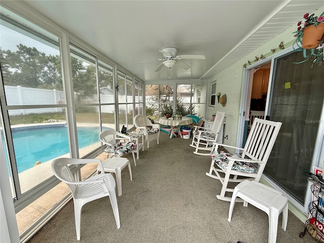 sunroom featuring ceiling fan