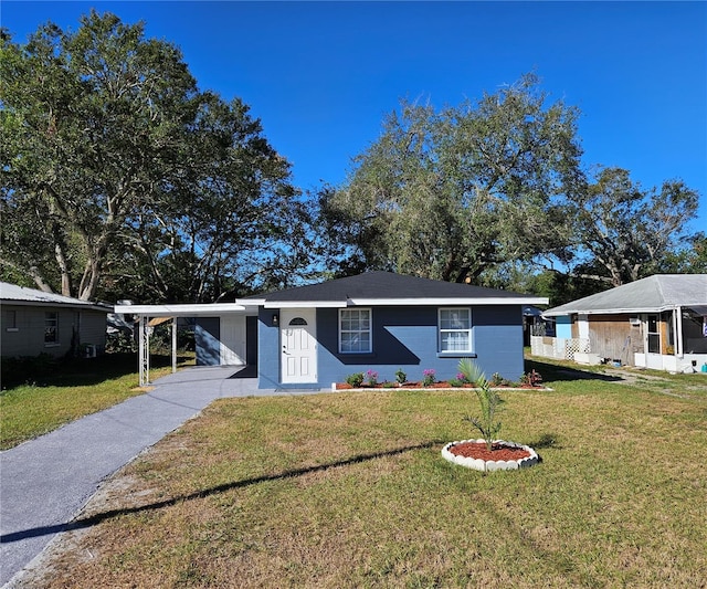 ranch-style house featuring a front yard and a carport