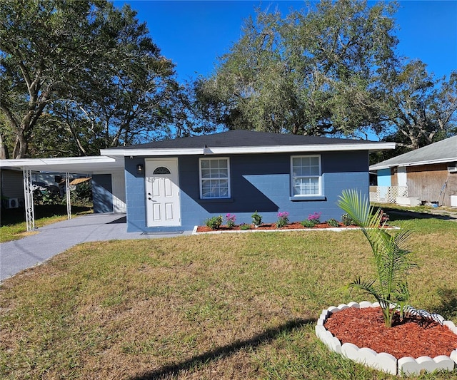 view of front facade with a front lawn and a carport