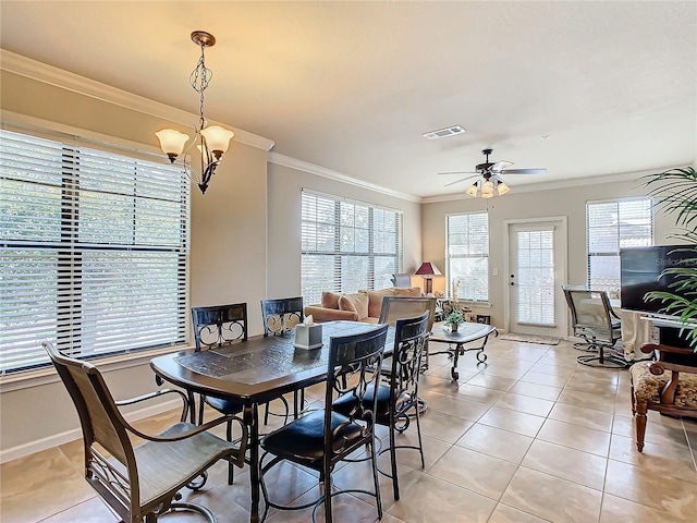 dining space with crown molding, light tile patterned floors, and ceiling fan with notable chandelier