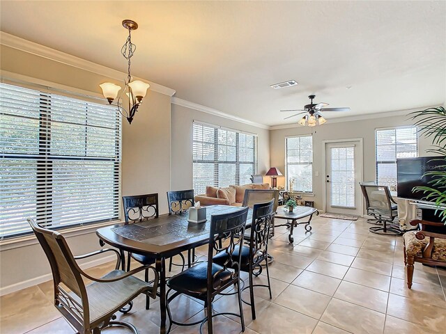 904 Charo Pkwy Unit 525, Davenport, FL 33897 - dining room with ornamental molding, healthy amount of natural light, a chandelier, light tile patterned floors, and a ceiling fan