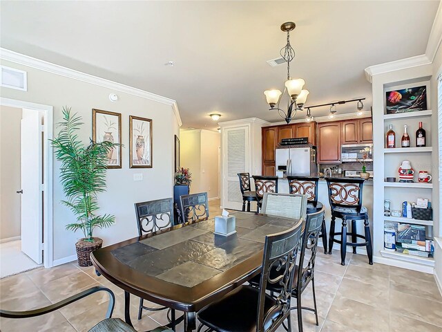 904 Charo Pkwy Unit 525, Davenport, FL 33897 - dining area featuring a chandelier, light tile patterned floors, and ornamental molding