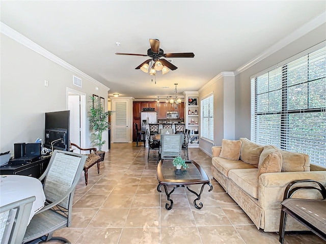 tiled living room featuring crown molding and ceiling fan with notable chandelier