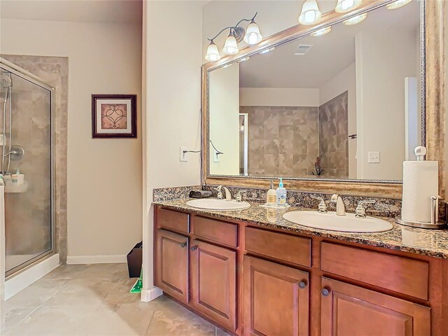 904 Charo Pkwy Unit 525, Davenport, FL 33897 - bathroom with a shower stall, double vanity, tile patterned floors, and baseboards