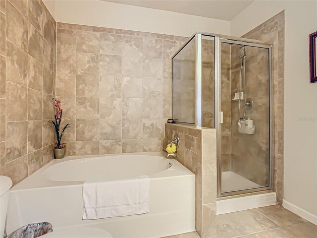904 Charo Pkwy Unit 525, Davenport, FL 33897 - bathroom with a bath, a stall shower, and baseboards