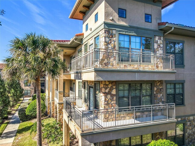 904 Charo Pkwy Unit 525, Davenport, FL 33897 - exterior space featuring stone siding, stucco siding, and a balcony