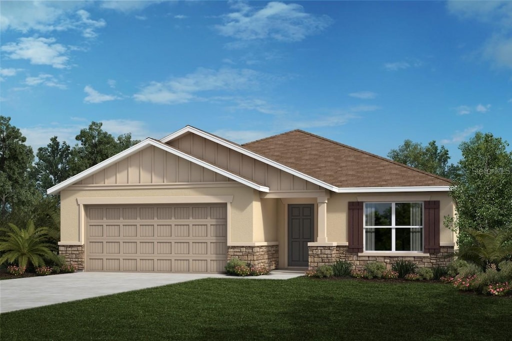 view of front of home featuring a garage and a front yard